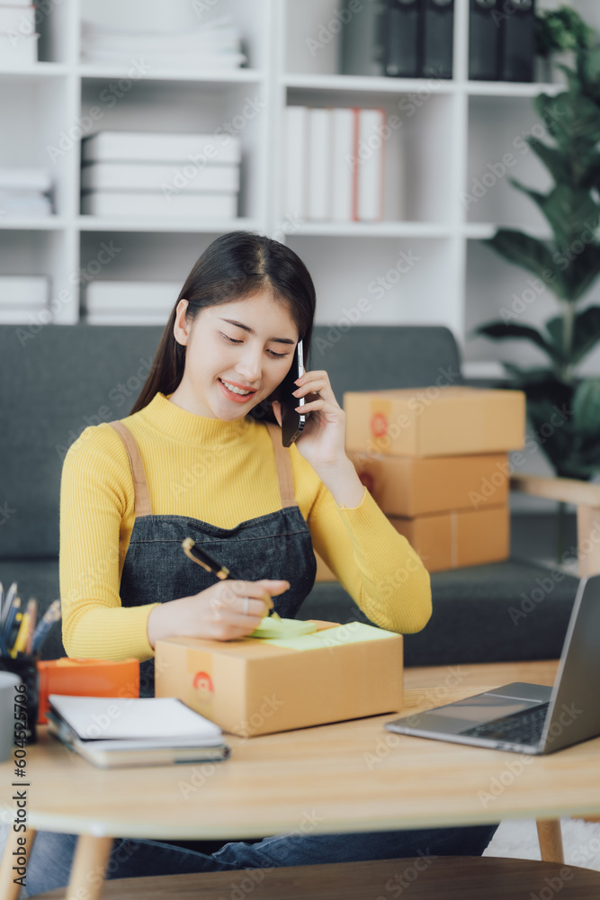 tarting Small business entrepreneur SME freelance,Portrait young woman working at home office, BOX,smartphone,laptop, online, marketing, packaging, delivery, SME, e-commerce concept tarting Small business entrepreneur SME freelance,Portrait young woman working at home office, BOX,smartphone,laptop, online, marketing, packaging, delivery, SME, e-commerce concept