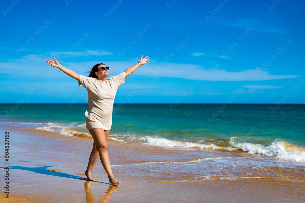 Beautiful woman walking on sunny beach
Beautiful woman walking on sunny beach