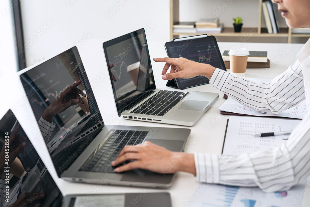Business woman trader is pointing statistics graph and checking Business woman trader is pointing statistics graph and checking