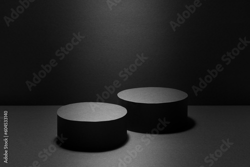 Abstract black stage with two round podiums in light ray with light spot mockup for presentation cosmetic products, goods, advertising, design, sale, showing, gradient in contemporary urban style.