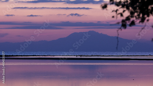 Beautiful purple sunset sky and ocean with tropical island of Atauro in Timor-Leste, Southeast Asia photo