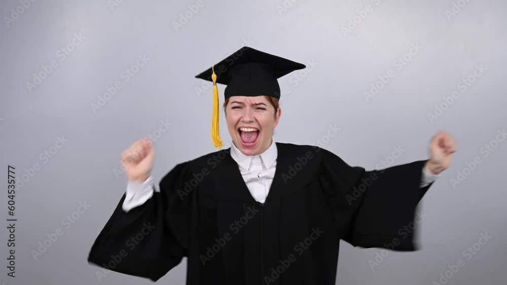 Caucasian woman dancing in graduation gown on white background. Caucasian woman dancing in graduation gown on white background.
