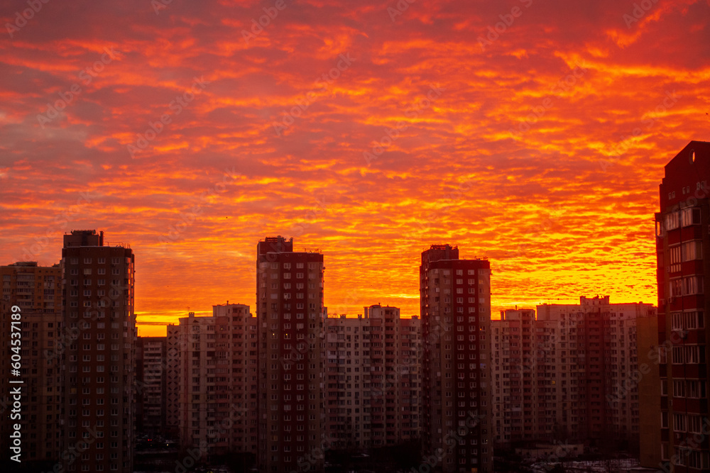 Colorful sunset in red among the sleeping area of high-rise buildings
