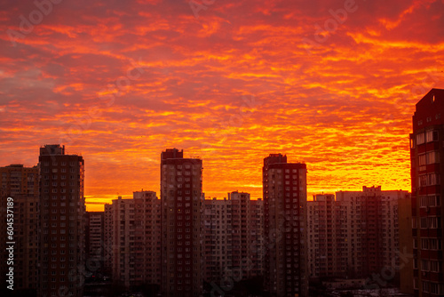 Colorful sunset in red among the sleeping area of high-rise buildings © dizfoto1973