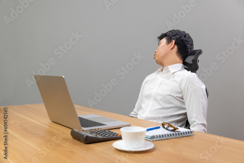 Man with narcolepsy is fall asleep on office desk..Narcolepsy is a sleep disorder that makes people very drowsy during the day. photo