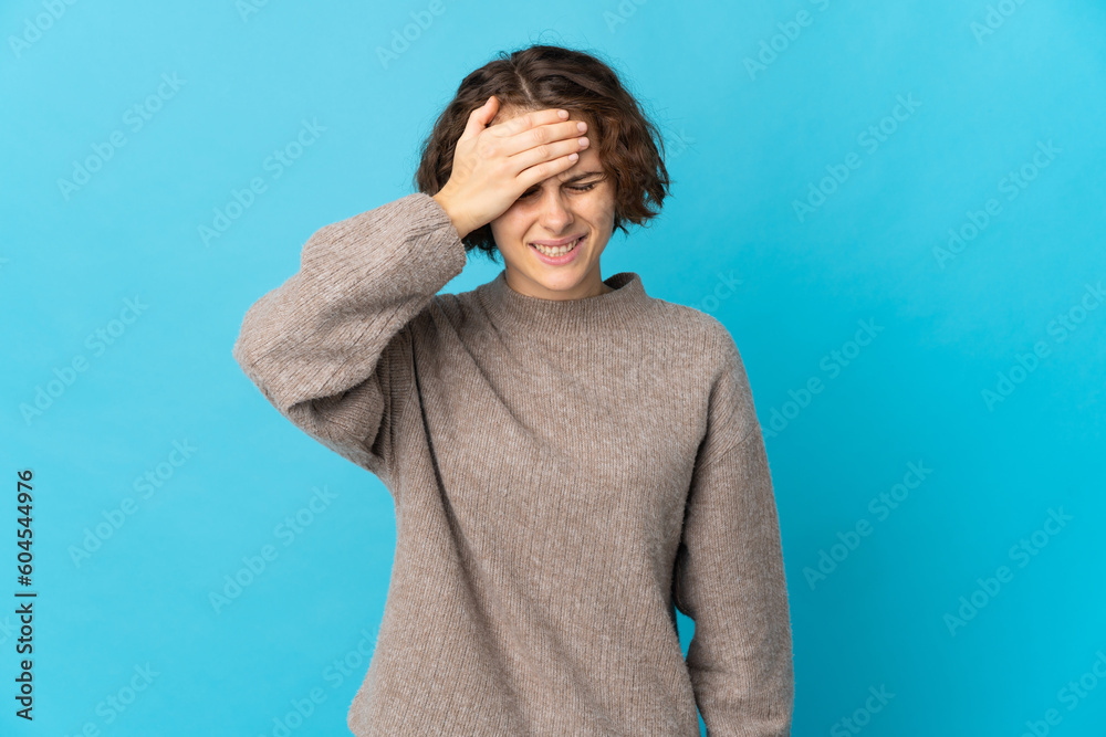 Young English woman isolated on blue background with headache Young English woman isolated on blue background with headache