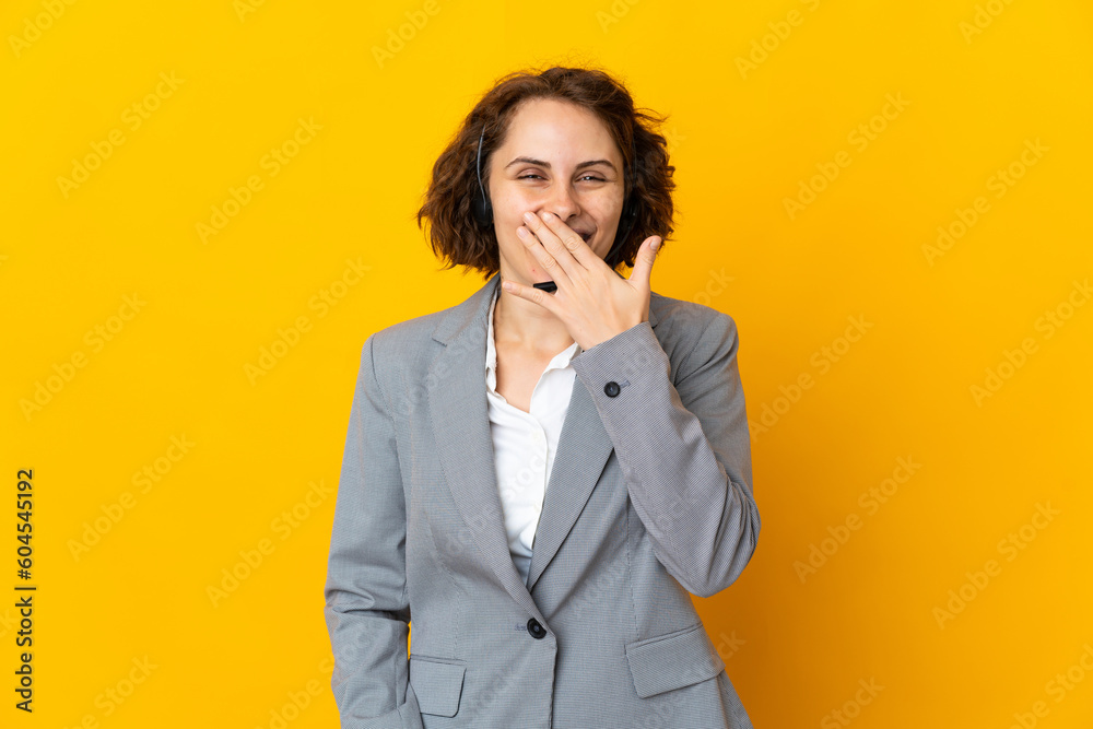 Young English woman isolated on yellow background happy and smiling covering mouth with hand Young English woman isolated on yellow background happy and smiling covering mouth with hand