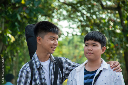 Young asian gay boys greeting, showing their love each other during the way to school at the weekend in asian country, soft and selective focus, concept for LGBT people events over the world.