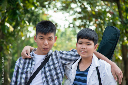 Young asian gay boys greeting, showing their love each other during the way to school at the weekend in asian country, soft and selective focus, concept for LGBT people events over the world. © Sophon_Nawit