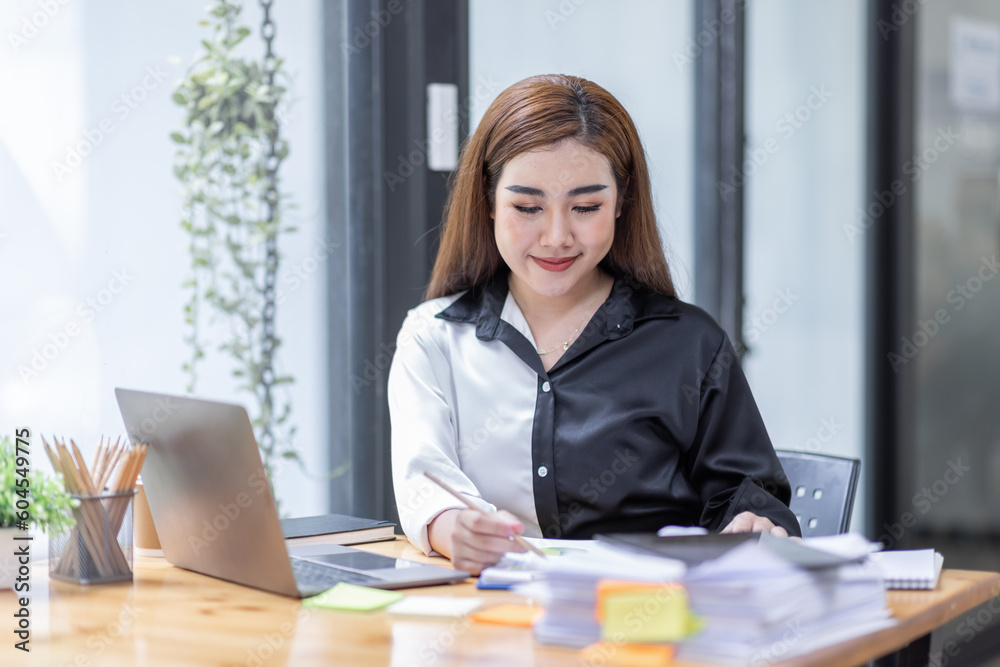 Business Asian woman working at office with documents on his desk, doing planning analyzing the financial report, business plan investment, finance analysis concept Business Asian woman working at office with documents on his desk, doing planning analyzing the financial report, business plan investment, finance analysis concept