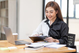 Business Asian woman working at office with documents on his desk, doing planning analyzing the financial report, business plan investment, finance analysis concept	