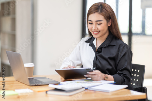 Business Asian woman working at office with documents on his desk, doing planning analyzing the financial report, business plan investment, finance analysis concept 