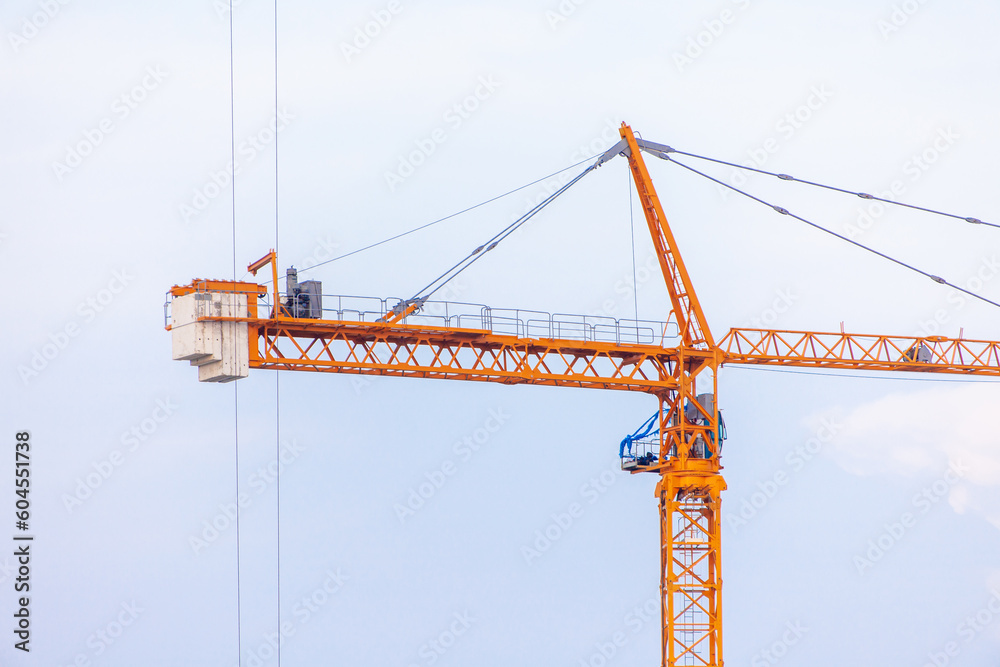 Crane. Crane for lifting things in construction against sunset sky atmosphere. communities and large industrial construction zones. Crane. Crane for lifting things in construction against sunset sky atmosphere. communities and large industrial construction zones.