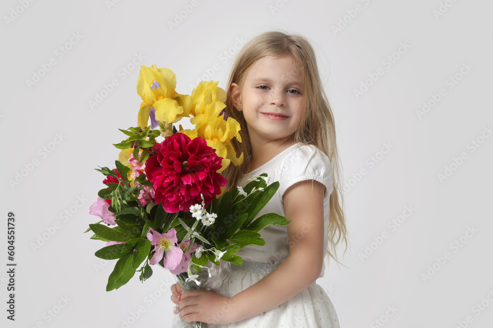 Studio portrait of beautiful little girl holding big colorful bouquet of various flowers. Studio portrait of beautiful little girl holding big colorful bouquet of various flowers.