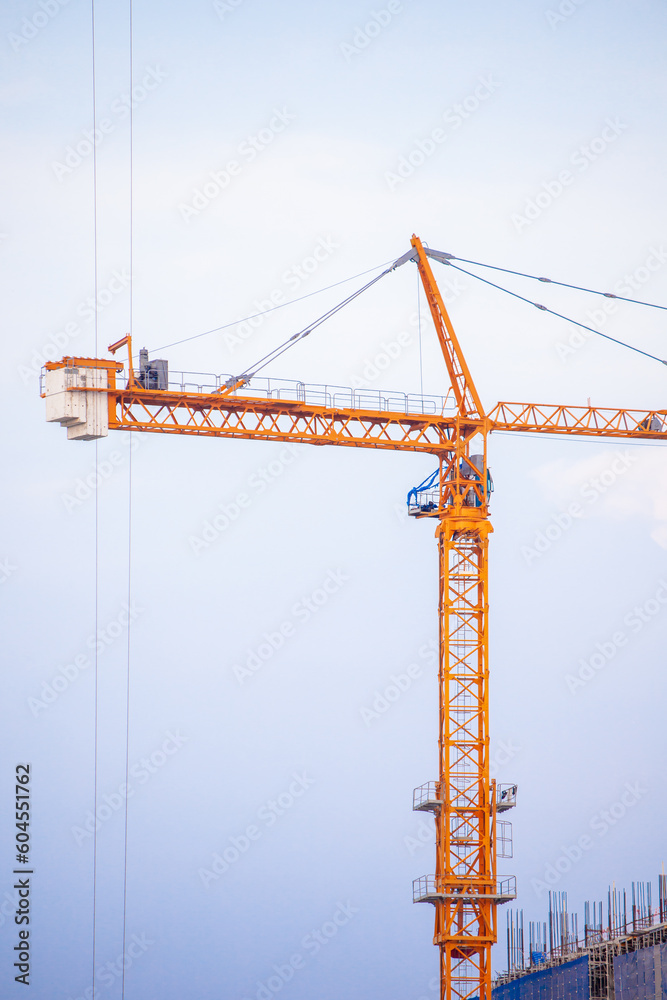 Crane. Crane for lifting things in construction against sunset sky atmosphere. communities and large industrial construction zones.