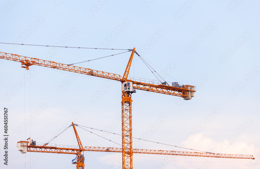 Crane. Crane for lifting things in construction against sunset sky atmosphere. communities and large industrial construction zones.