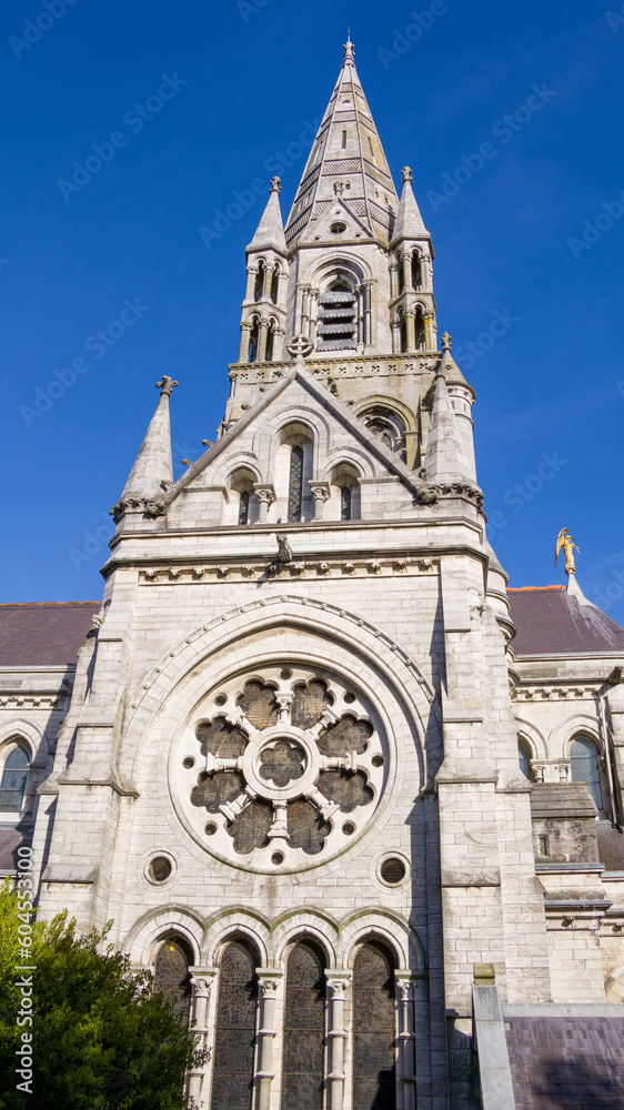 The spires of the Anglican Cathedral of St. Fin Barre in the Irish city of Cork. A Christian church in the Neo-Gothic style. sky over the church. Christian religious architecture.