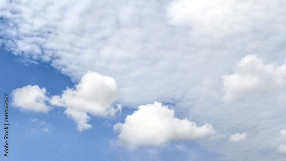 White fluffy cloud with blue sky background.  Cloudscape background.  