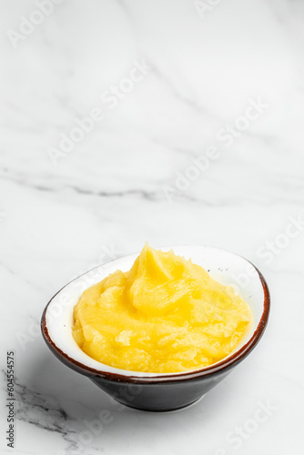 ghee oil. Ghee or clarified butter in jar on a light background. vertical image. top view. place for text