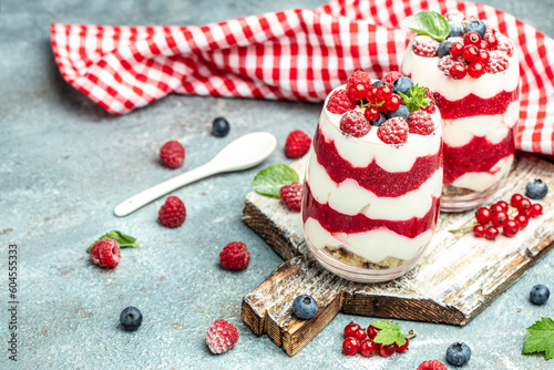 Cranachan raspberry dessert in jar on a light background. Restaurant menu, dieting, cookbook recipe top view