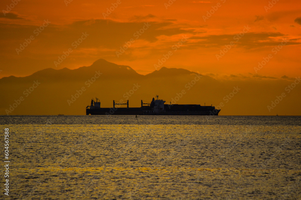 construction vessel at sunset, ship silhouette, seaside