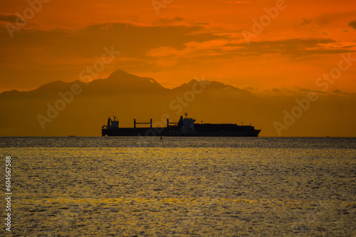 construction vessel at sunset, ship silhouette, seaside