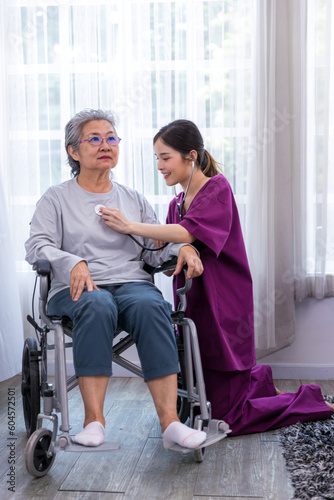 Caregiver nurse take care a Senior patient walking in park. Nurse helping senior Woman.