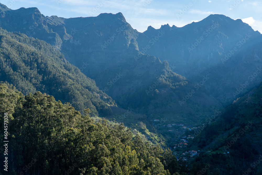 A breathtaking aerial view of the Madeira mountain range, showcasing its lush valleys and trees with tranquil plateaus. Nature at her finest!