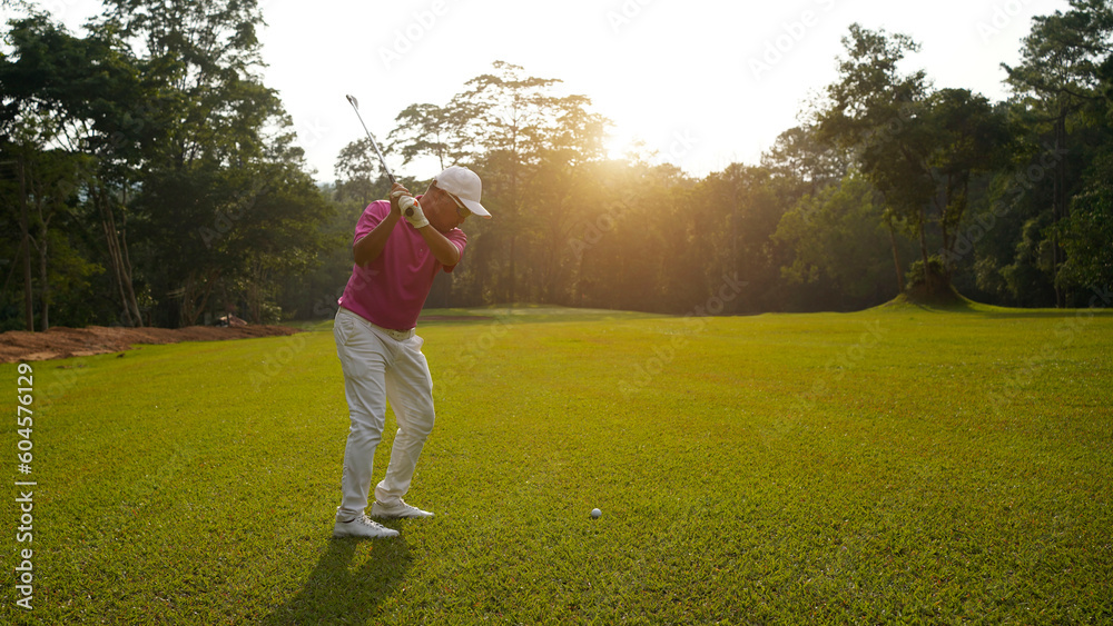 Golfer playing golf in the evening golf course, on sun set evening time. Golfer playing golf in the evening golf course, on sun set evening time.