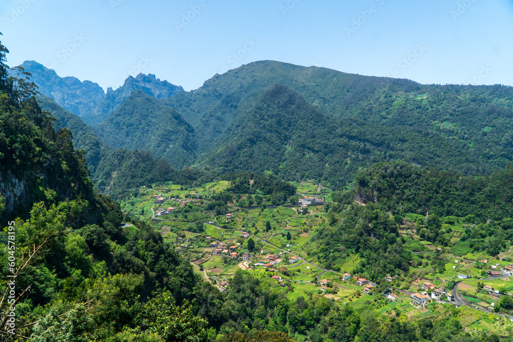 Mountain landscape with vegetation beautiful background of Madeira mountains. Green landscape cloudy sky