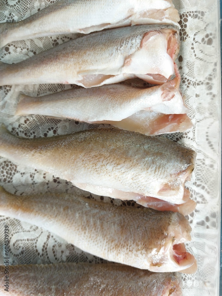 Raw fish fillets on a white background. Close-up. Raw fish fillets on a white background. Close-up.