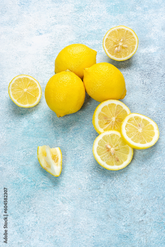 Fresh lemons on bright background. Lemon fruit citrus. Composition with whole, slices of lemons. Fresh lemons on bright background. Lemon fruit citrus. Composition with whole, slices of lemons.