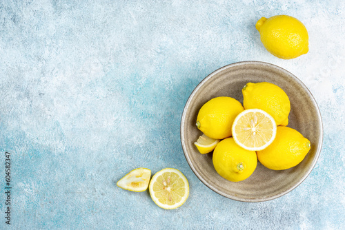 Fresh lemons on bright background. Lemon fruit citrus. Composition with whole, slices of lemons.