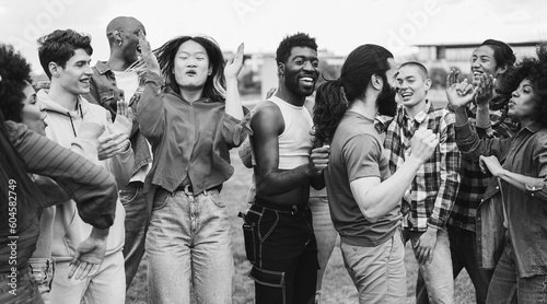 Photography Young diverse people having fun outdoor dancing together - Focus on bearded man