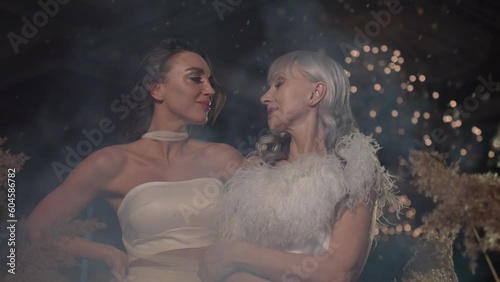 The older woman wears a simple corsage.