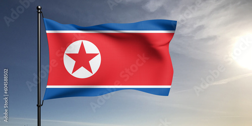 Korea, North national flag cloth fabric waving on beautiful grey sky Background.