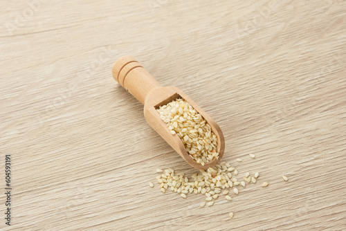Organic White Sesame Seeds (Sesamum indicum) or Wijen, served in wooden spoon on wooden background
 photo