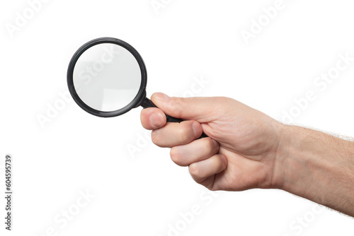 Man's hand, holding classic styled magnifying glass, closeup isolated on white background