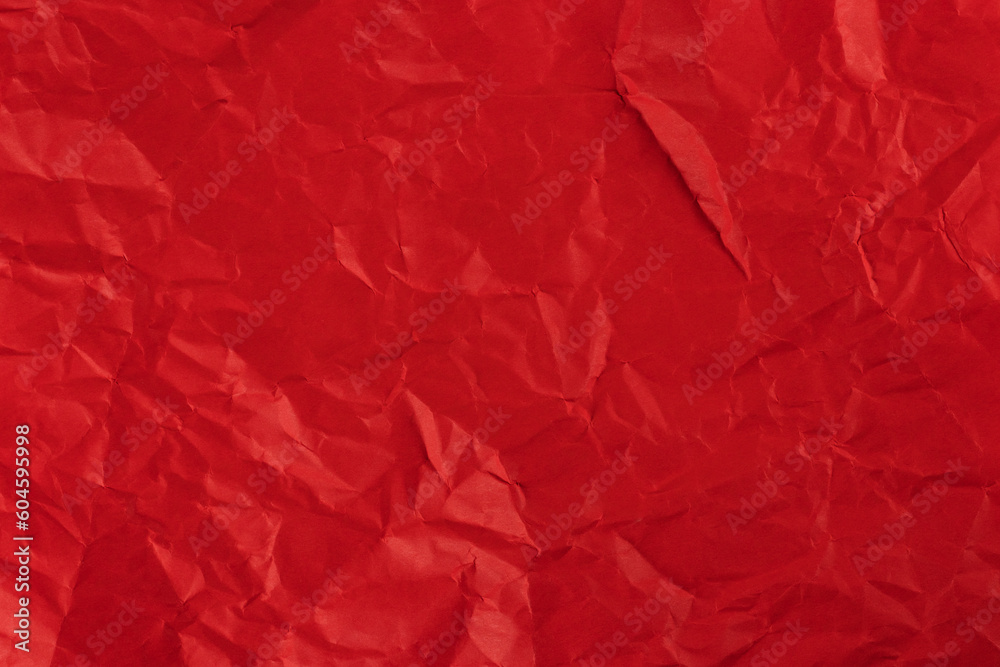 Red crumpled paper texture background.