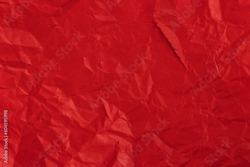 Red crumpled paper texture background.