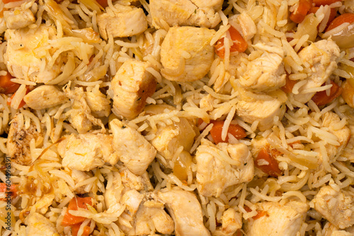 Tasty pilaf with chicken as background.