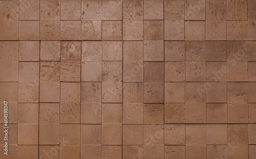 The texture of the wall is made of beige natural stone blocks or brick decorative tiles