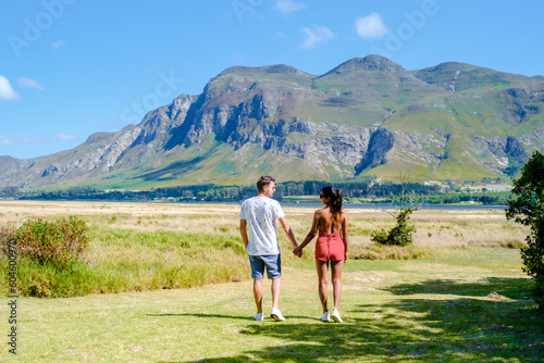 A couple man and women mid age in front of their lodge during a vacation in South Africa, Mountains and grassland near Hermanus at the Garden Route Western Cape South Africa Whale coast. 