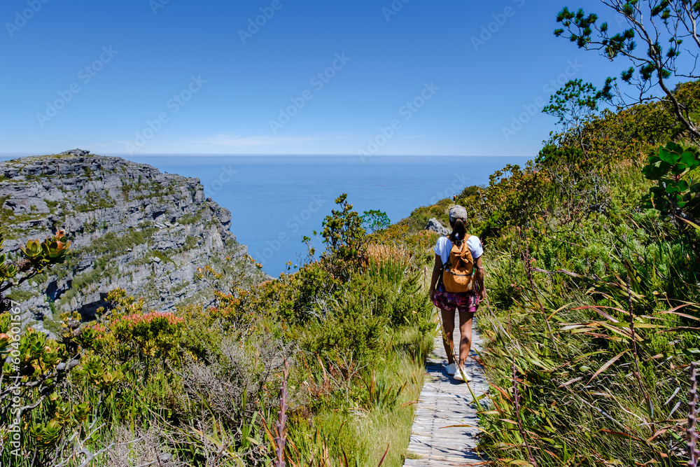 Fototapeta premium view from the Table Mountain in Cape Town South Africa, view over the ocean, and Lion's Head from Table Mountain Cape Town, Asian women hiking in the mountains of Cape Town South Africa