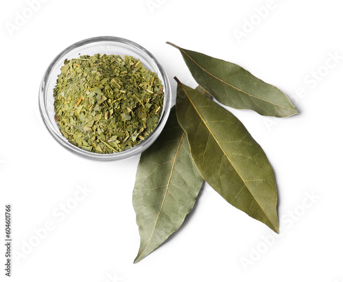 Whole and ground aromatic bay leaves on white background, top view