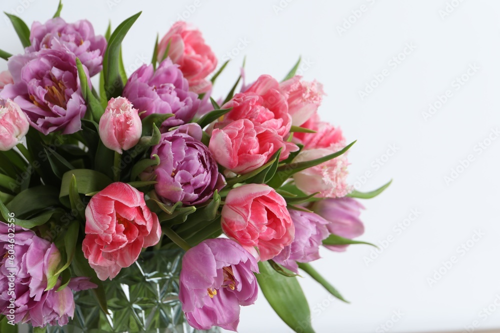 Beautiful bouquet of colorful tulip flowers on white background, closeup. Space for text