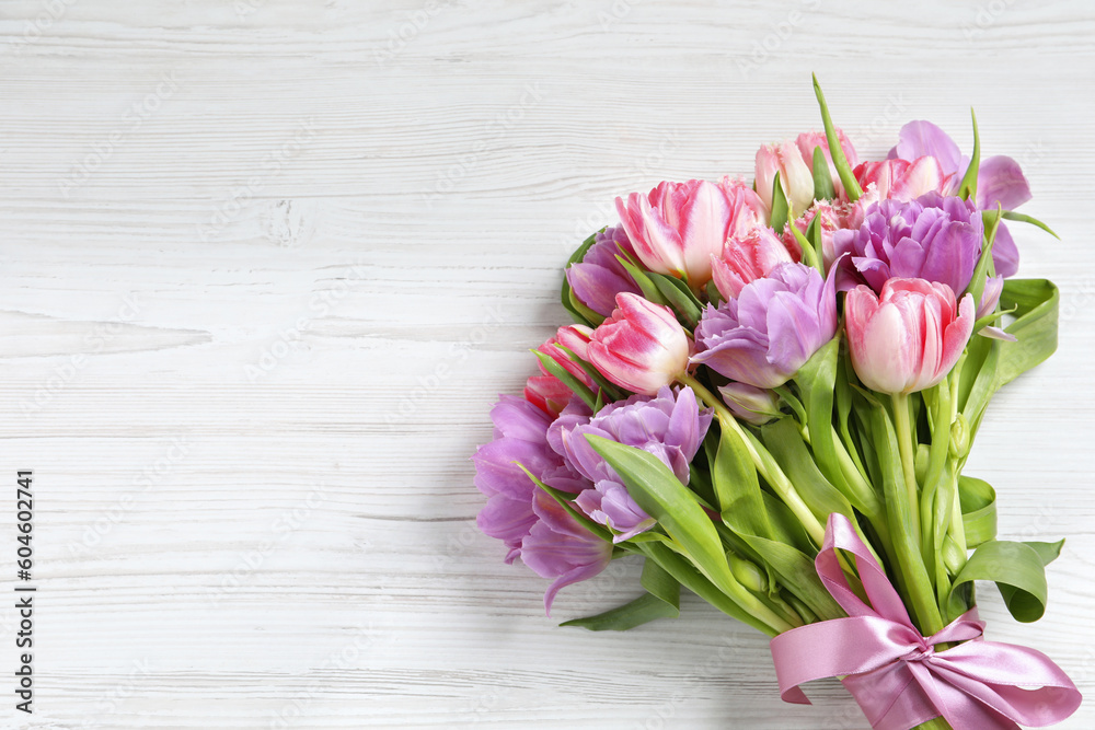 Beautiful bouquet of colorful tulip flowers on white wooden table, top view. Space for text Beautiful bouquet of colorful tulip flowers on white wooden table, top view. Space for text