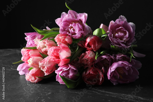 Beautiful bouquet of colorful tulip flowers on black table