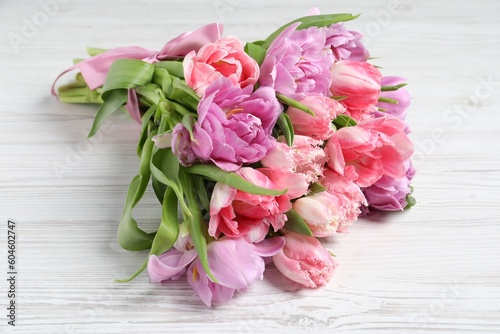 Beautiful bouquet of colorful tulip flowers on white wooden table