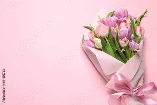 Fototapeta Naklejka Na Ścianę i Meble -  Beautiful bouquet of colorful tulip flowers on pink background, top view. Space for text